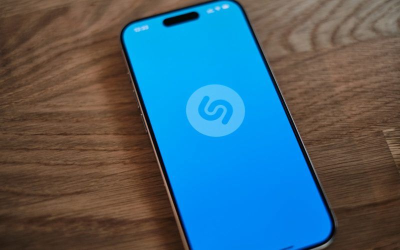 A blue phone sitting on top of a wooden table