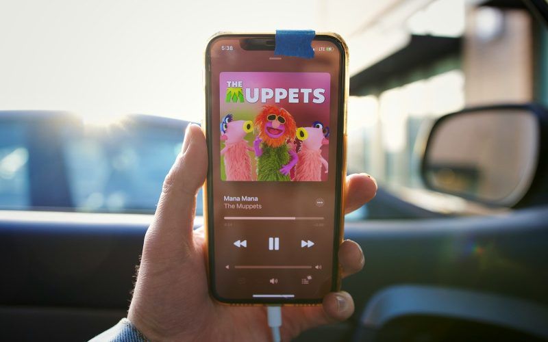 a person holding up a cell phone with the muppets on it